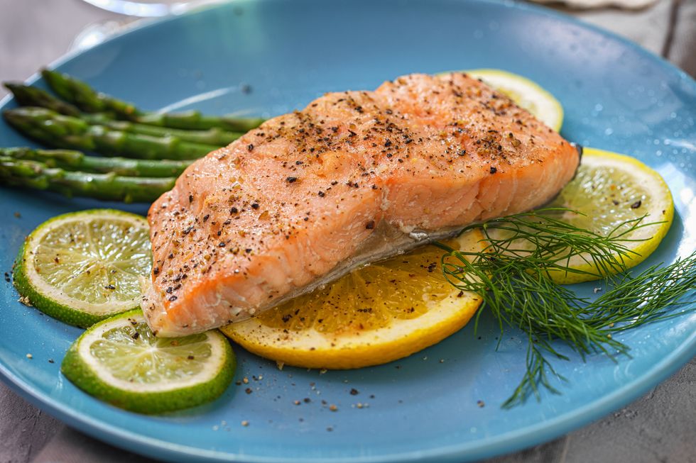 https://hips.hearstapps.com/hmg-prod/images/grilled-fillet-of-salmon-with-asparagus-served-on-a-royalty-free-image-1640715356.jpg?crop=1xw:1xh;center,top&resize=980:*