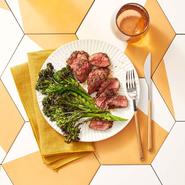 grilled hanger steak with charred broccolini on a plate