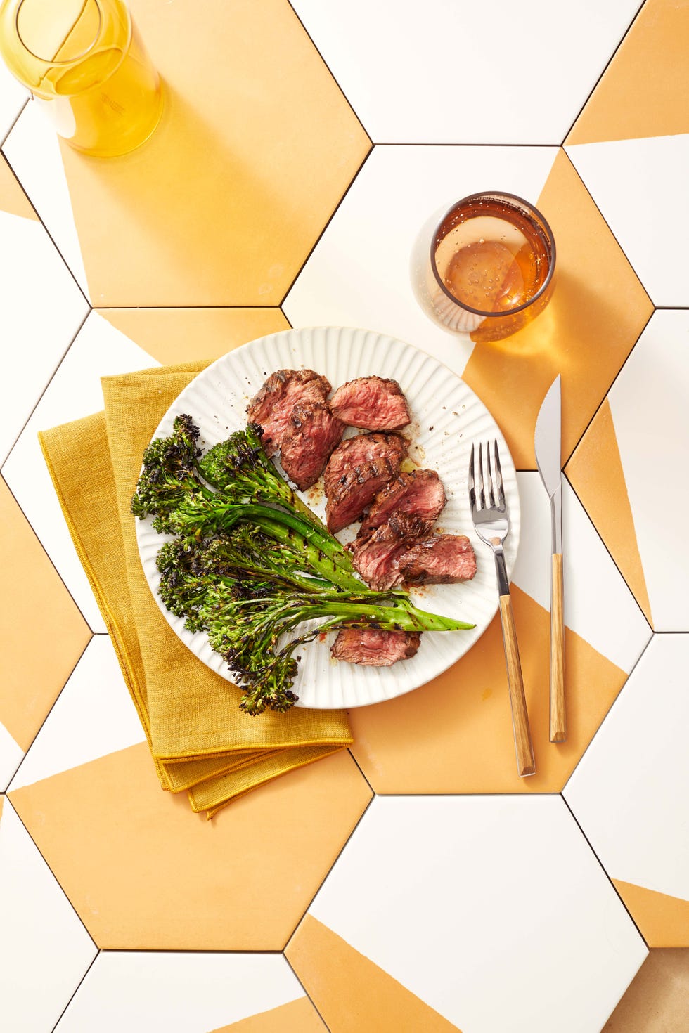 grilled hanger steak with charred broccolini on a plate