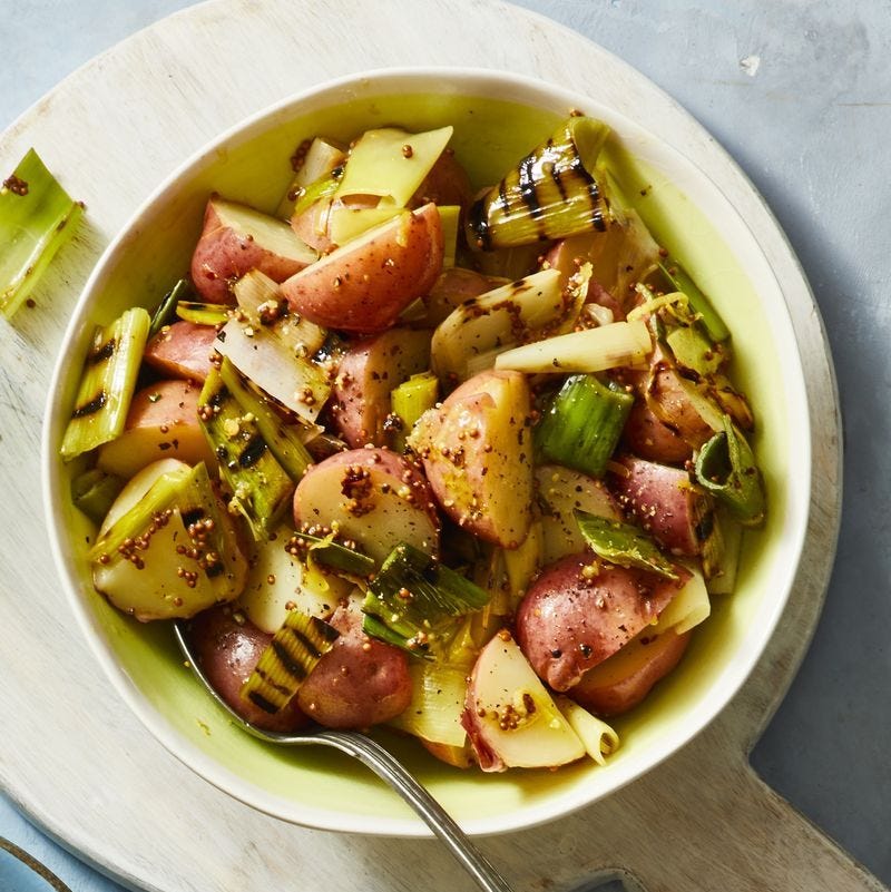 grilled leek potato salad in a white bowl