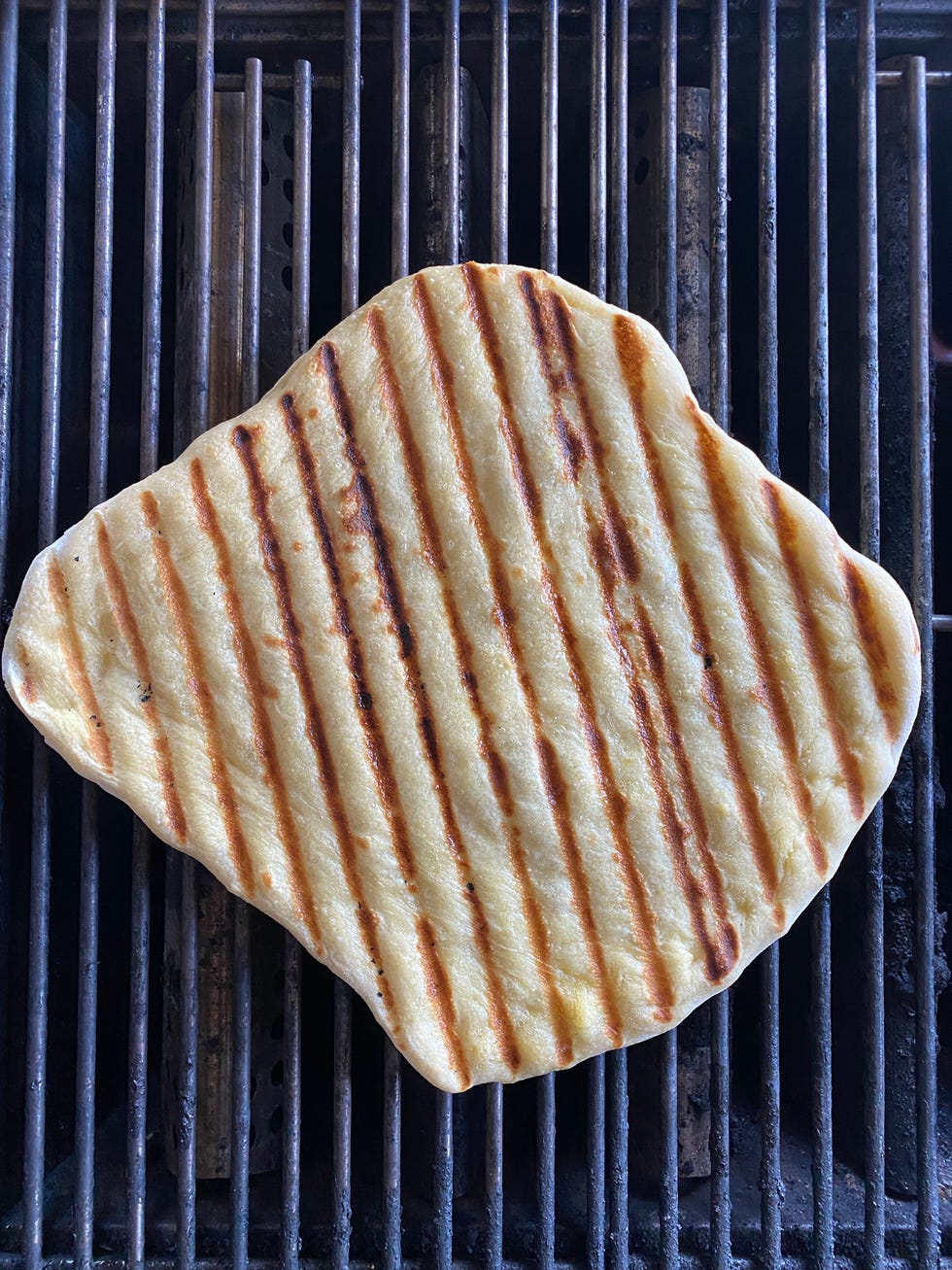 pizza dough on grill with grill marks