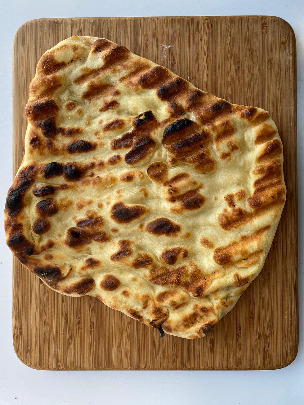 grilled pizza on cutting board