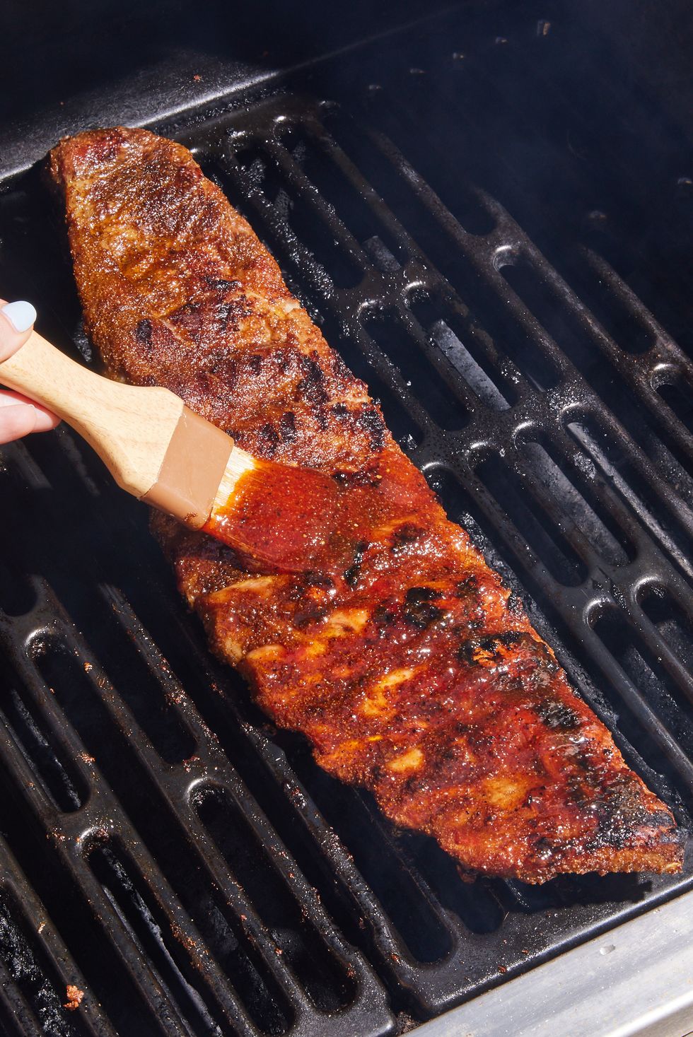 https://hips.hearstapps.com/hmg-prod/images/grilled-ribs-sauce-1649951759.jpg?crop=0.668xw:1.00xh;0.184xw,0&resize=980:*