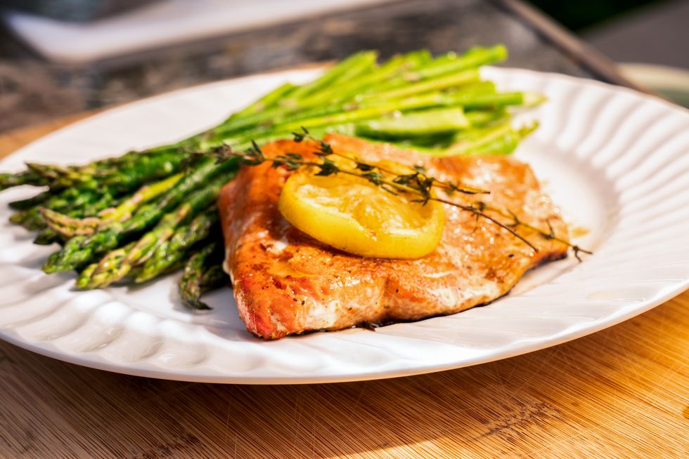 grilled salmon on a plate with asparagus