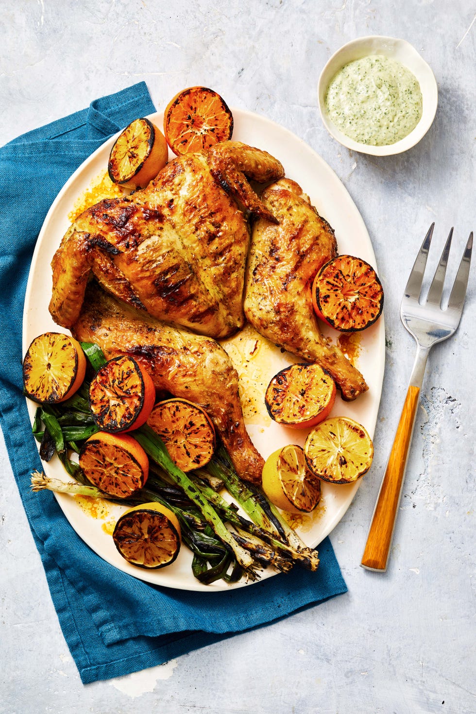 grilled spatchcock chicken with lemons and scallions