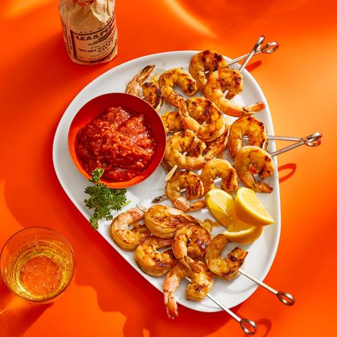 grilled shrimp cocktail on a triangular platter with cocktail sauce