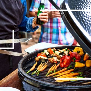 man holding beer and tongs grilling vegetables on grill