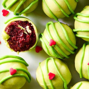 Grinchy Christmas Cake Bites green covered cake bites with red hearts