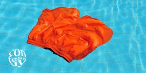 a pair of orange swim trunks lying on the bottom of a pool