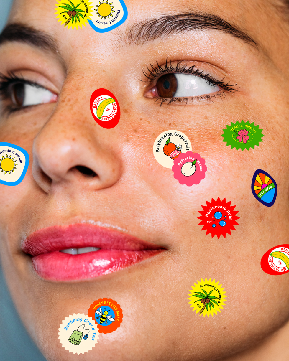 woman looking to the left with fruit stickers on her face