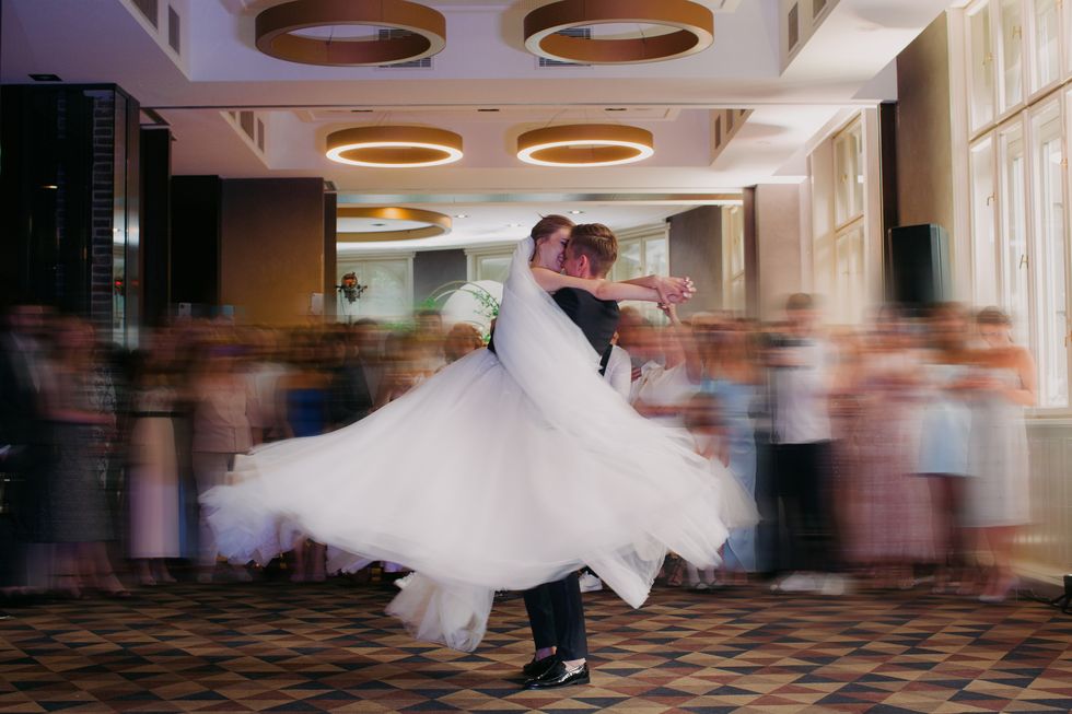 groom raised up his bride in the passionate dance