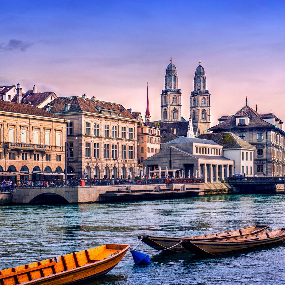 grossmunster cathedral with river limmat in zurich at sunset