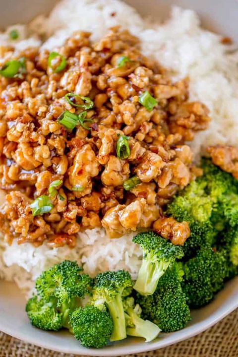 ground orange chicken with broccoli over rice