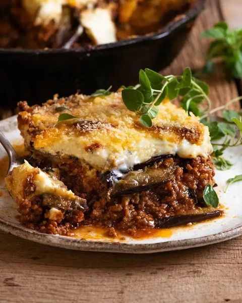 greek moussaka slice on plate with greens