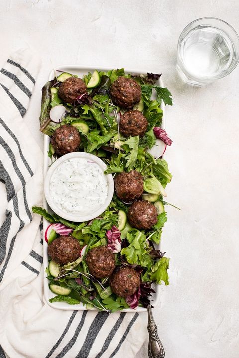 lamb meatballs on salad with dressing on side