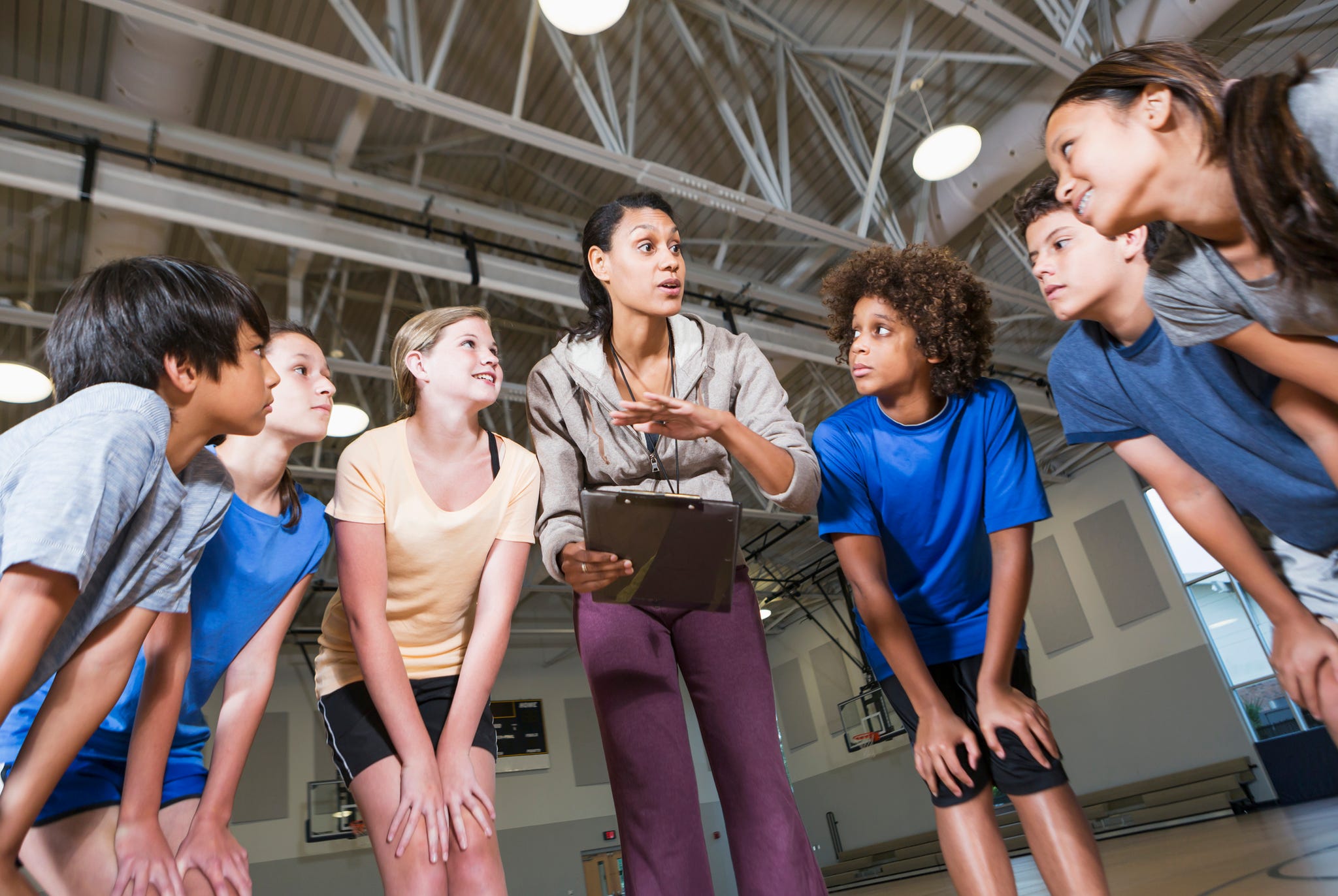 group of children with coach in school gym