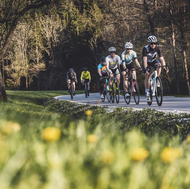 group of cyclist cycling on a country road