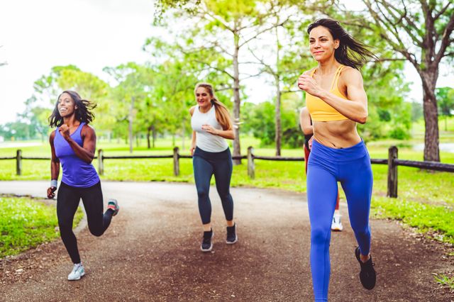 group of female athletes sprinting in a friendly race