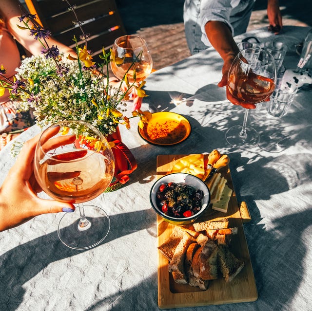 group of female friends drinking wine outside