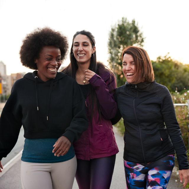 a group of female friends walking and talking after doing some outdoor exercise