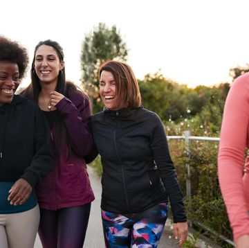 a group of female friends walking and talking after doing some outdoor exercise