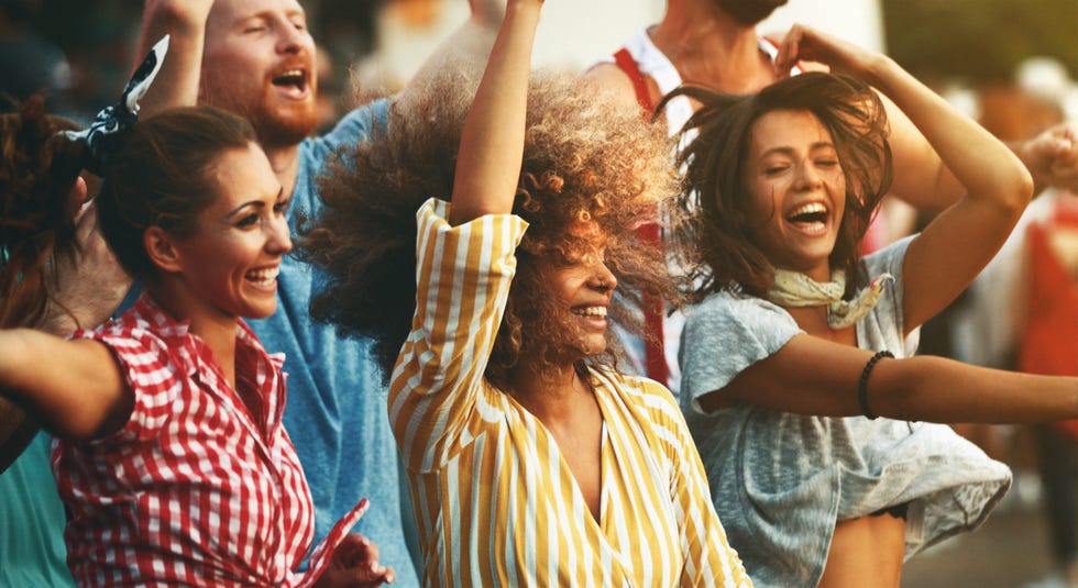 group of friends dancing at a concert