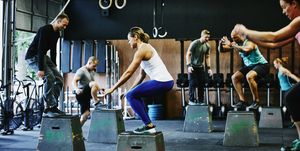 Group of friends doing box jumps during workout