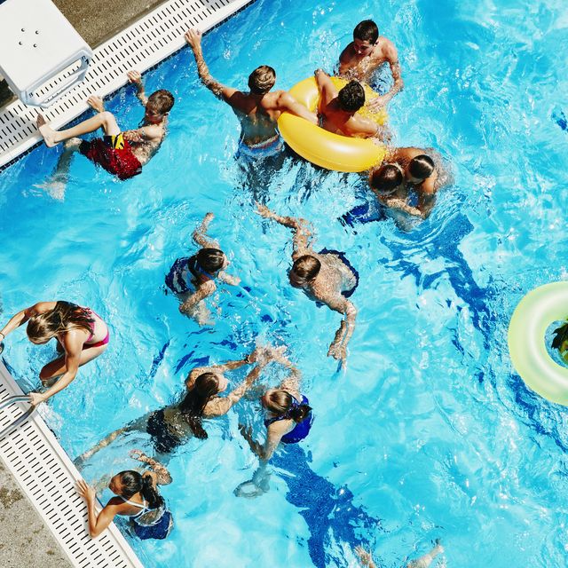 group of friends playing together in outdoor pool