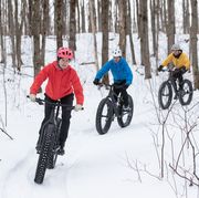 group of friends riding their fat bike in the snow in ontario, canada
