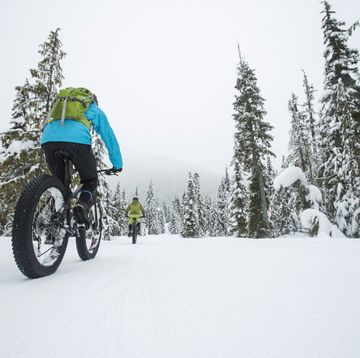 group of friends riding their fat bike in the snow in whistler, canada