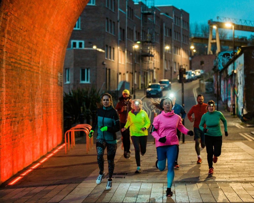 Group Of Friends Running Together At Night