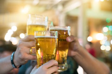 a group of friends with drinks at a nightclub young people are enjoying