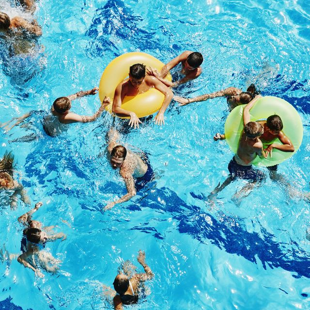 group of kids playing together in outdoor pool