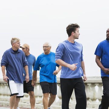 group of men wearing blue shirts, power walking