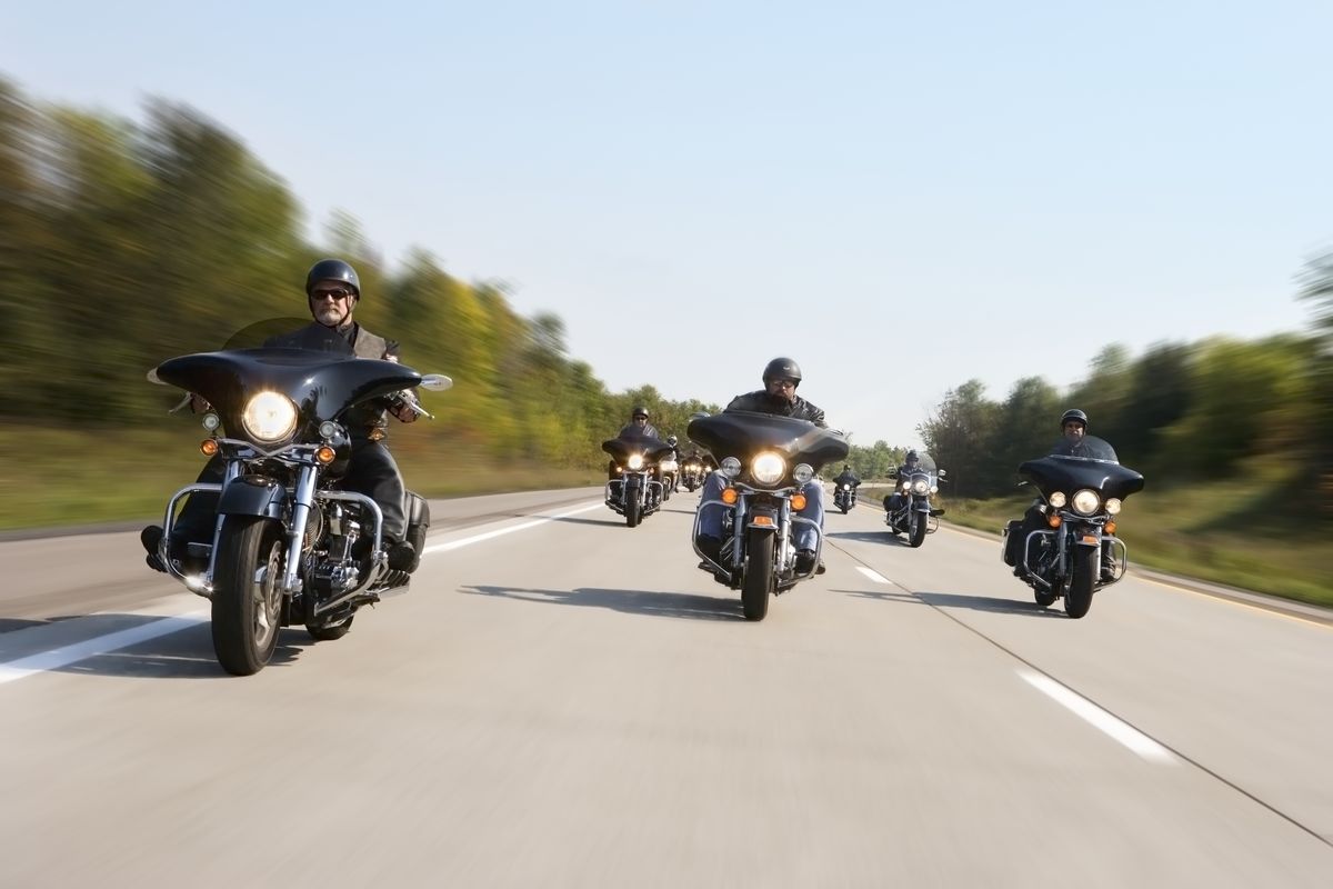 Group of motorcyclists riding, (blurred motion)