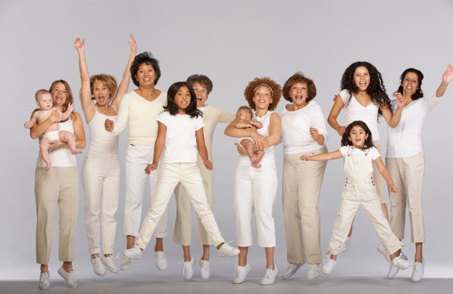 group of multi generational family, jumping, portrait