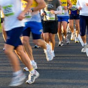 group of runners taking a bend, half marathon distance, how many miles is a half marathon