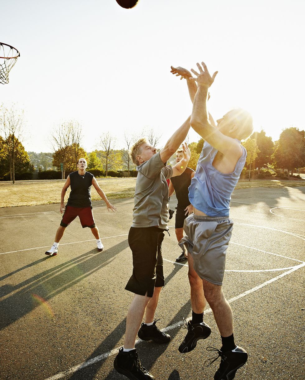 group of senior and mature men playing basketball