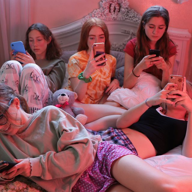 group of teenage girls using their cell phones