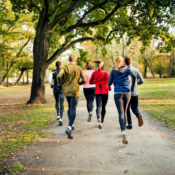 a group of unrecognisable runners freak running through the park