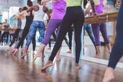 group of women doing barre  workout
