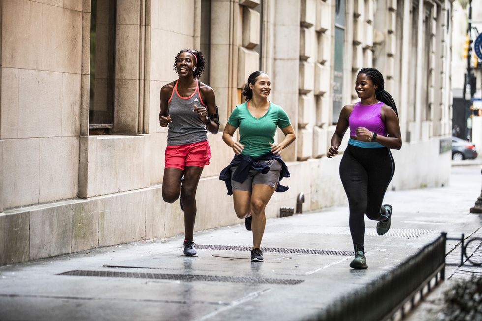 group of women ankle running through urban area