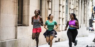 group of women running through urban area