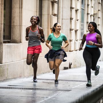 group of women running through urban area
