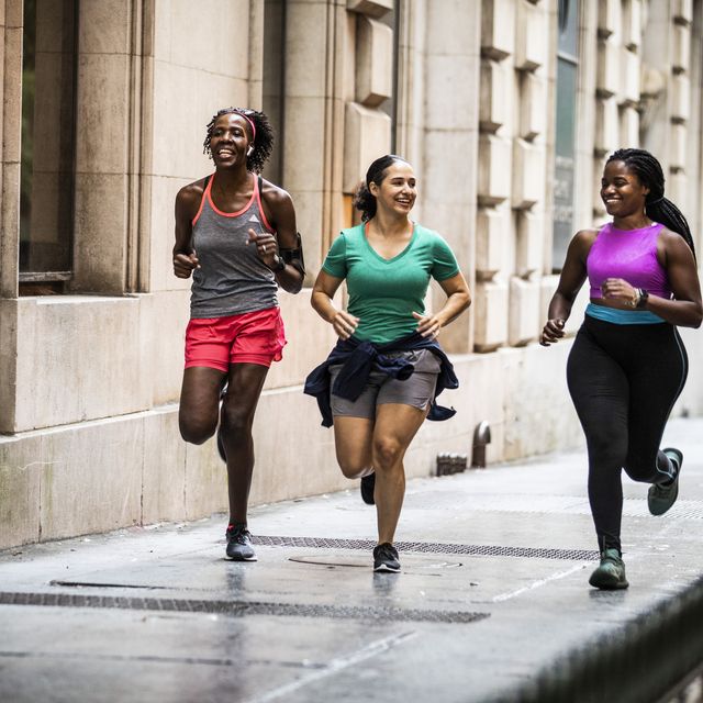 group of women running through urban area