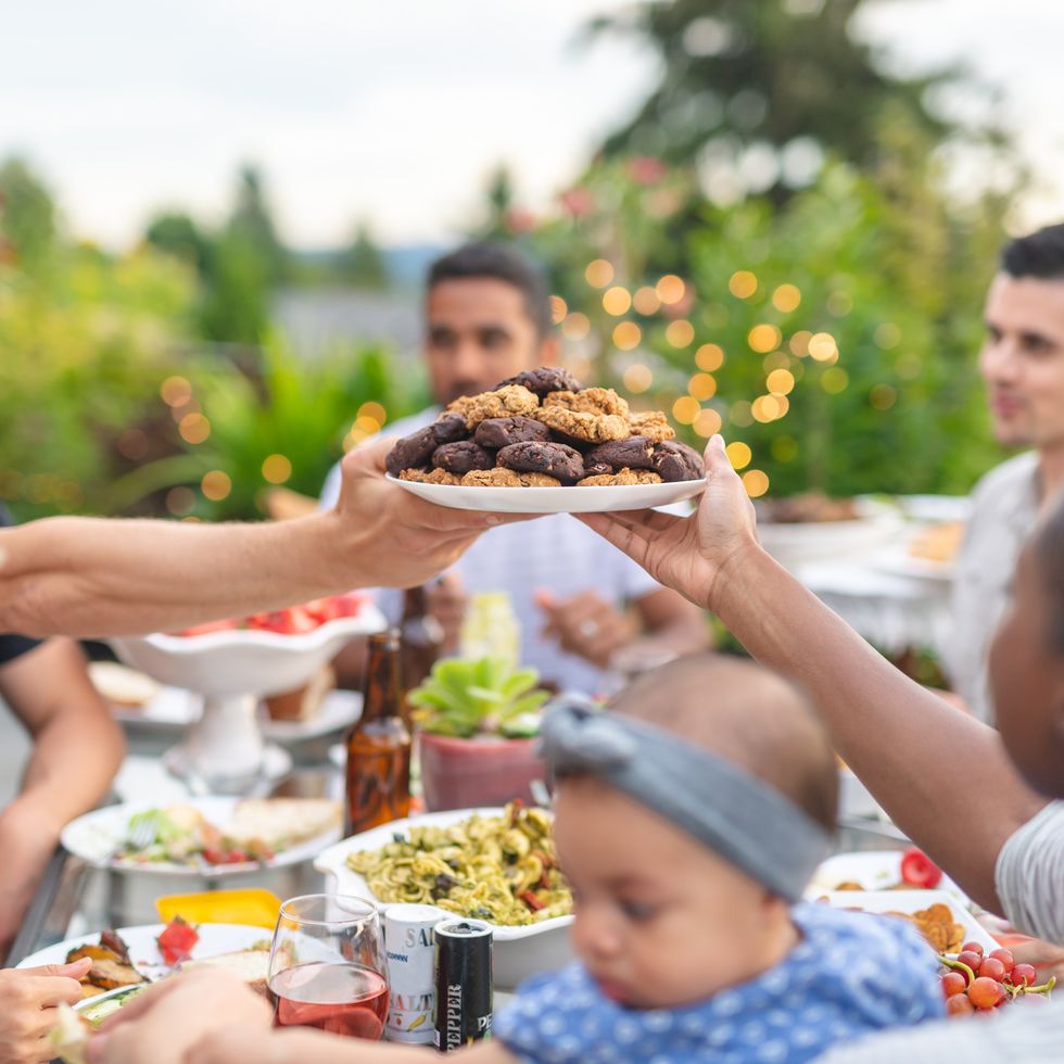 a group of young adult friends dining al fresco on a patio