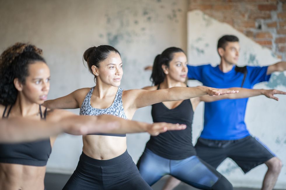 a group of young people in a yoga pose