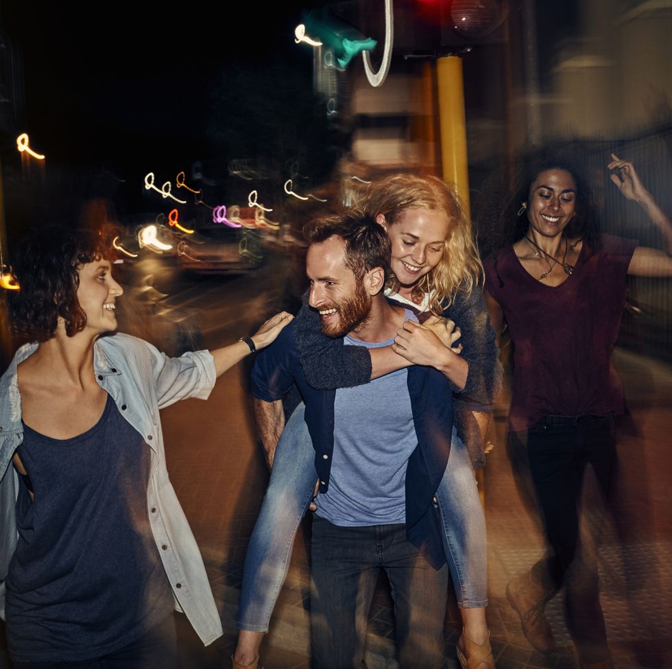 group of young people in the city at night