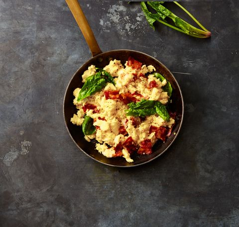 gruyere, bacon, and spinach scrambled eggs in a bowl