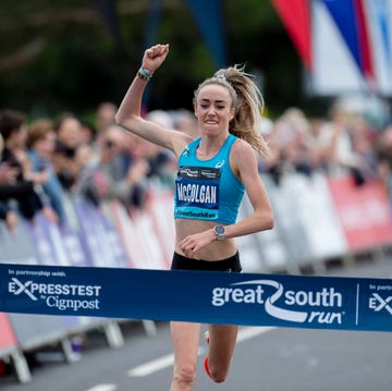 woman punches her fist in the air as she gets ready to win a running race woman punches her fist in the air as she gets ready to win a running race